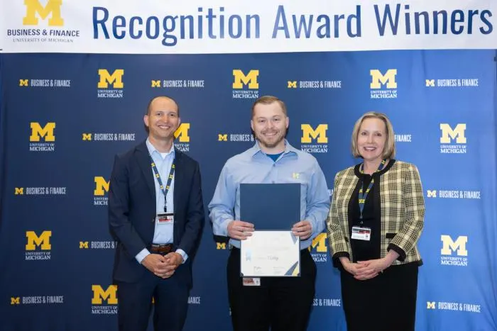 Recognition recipients accepting award