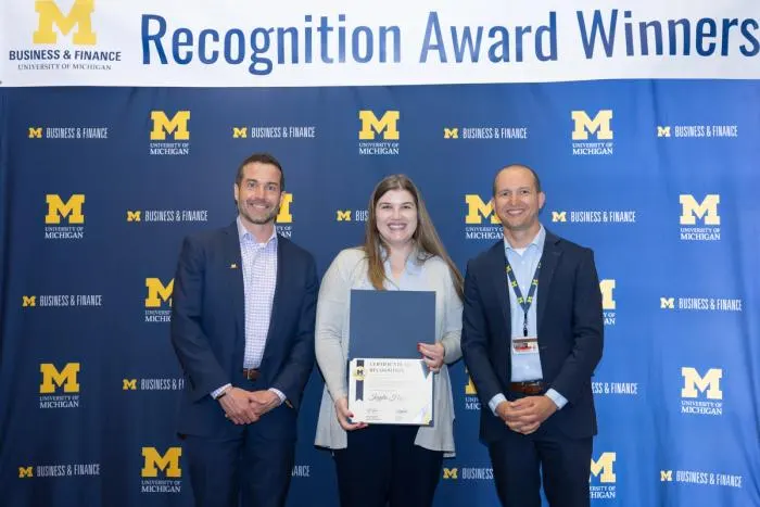Recognition recipients accepting award
