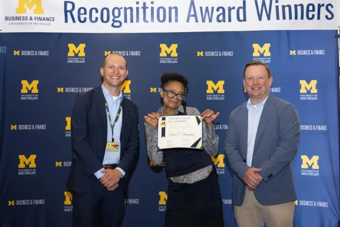 Recognition recipients accepting award
