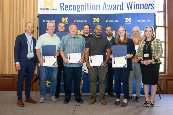 Recognition recipients accepting award