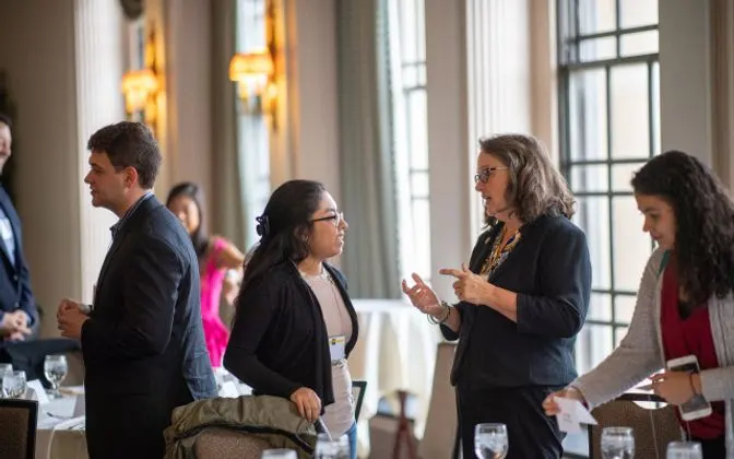 A group of people talking at an event