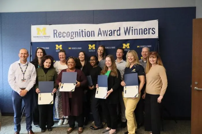 Recognition recipients accepting award