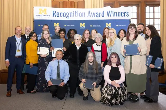 Recognition recipients accepting award