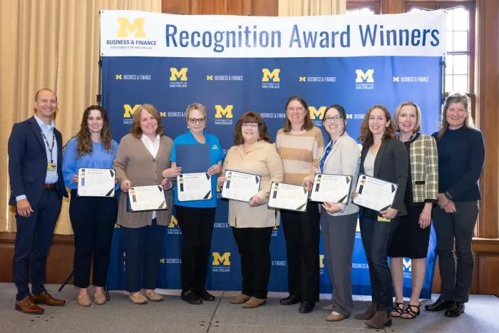 Recognition recipients accepting award