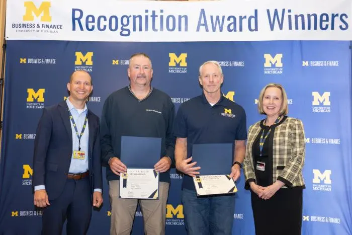 Recognition recipients accepting award