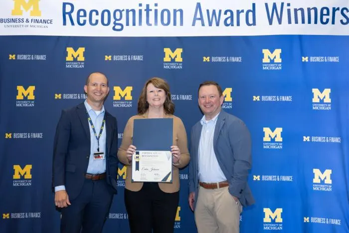 Recognition recipients accepting award
