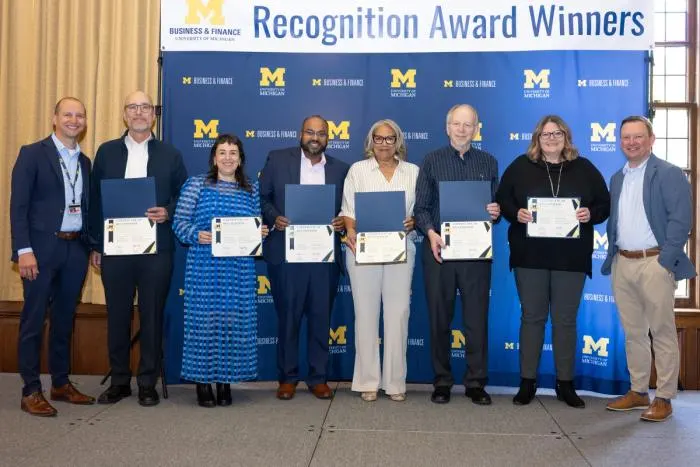 Recognition recipients accepting award