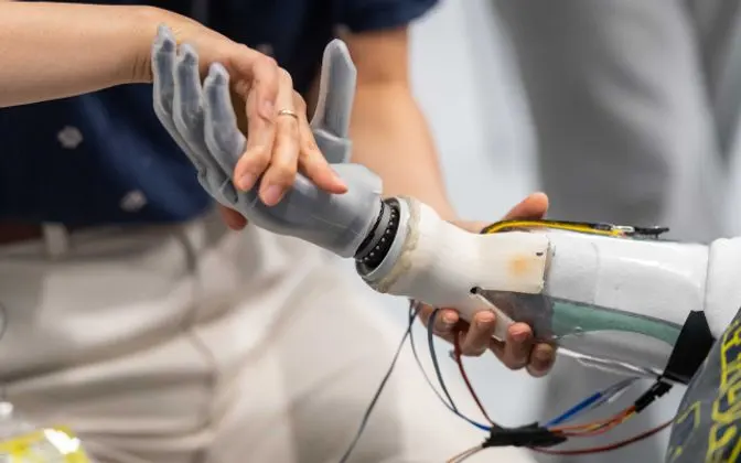 A person working with a robotic arm